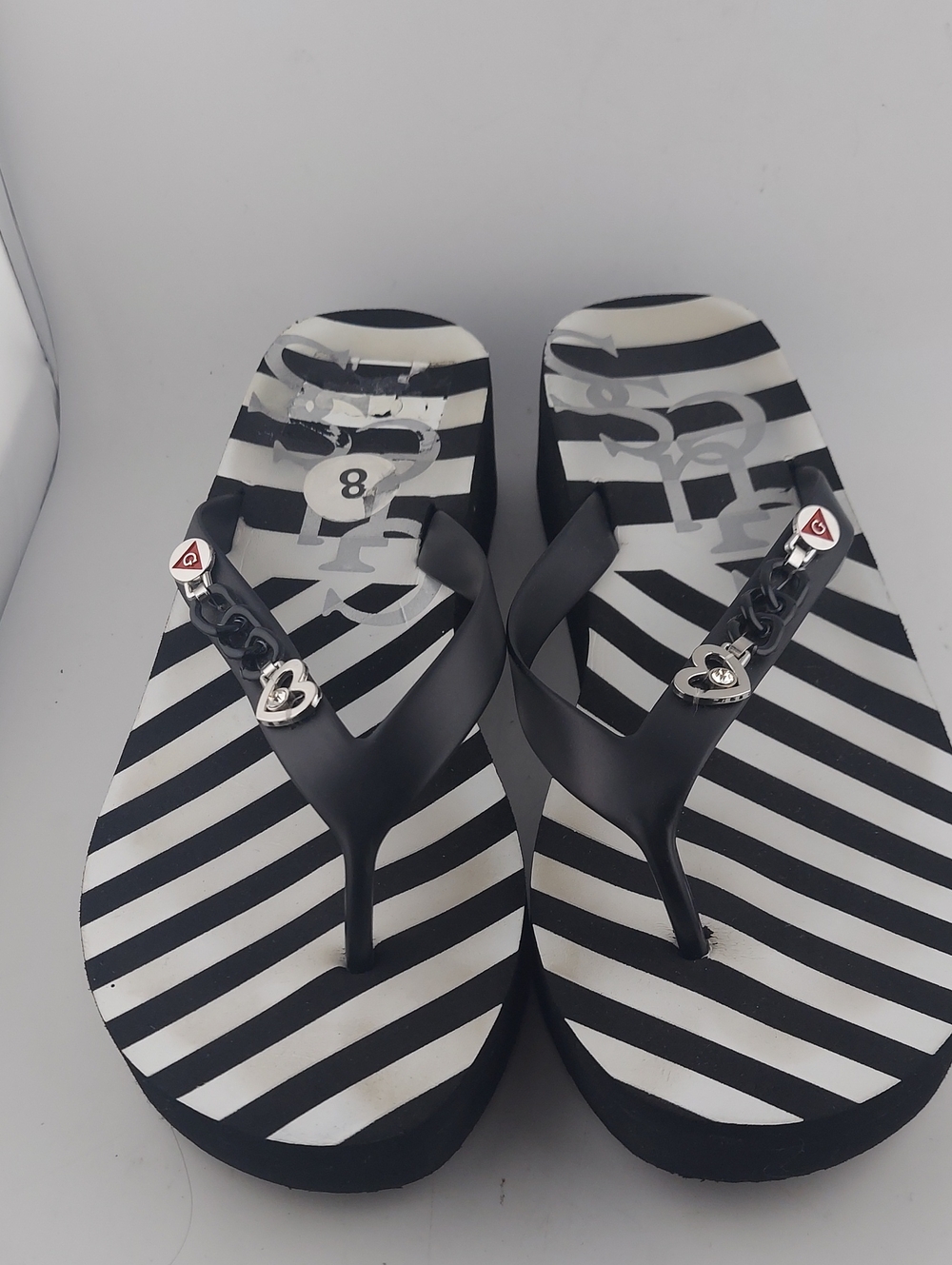 GUESS, Black & White Striped Women's Wedge Flip Flops with Chain Accent